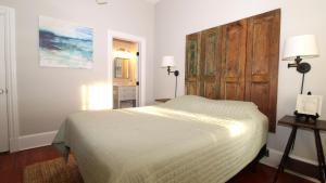 a bedroom with a bed and a wooden cabinet at The Bayberry House in Cape May
