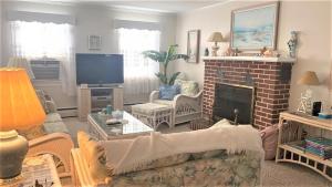 a living room with a couch and a fireplace at Rulons Cape May Diamond, 1St in Cape May