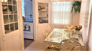 a kitchen with a glass table and chairs at Rulons Cape May Diamond, 1St in Cape May