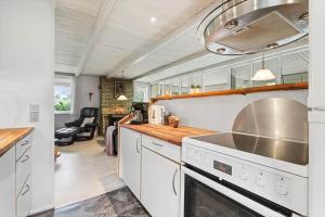 a kitchen with white cabinets and a stove top oven at 30073-Ulfborg-Grastensborgvej-35 in Ulfborg +23 photos