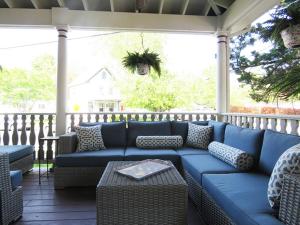 a blue couch sitting on a screened porch at Breezes On Broad in Cape May