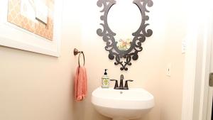 a bathroom with a sink and a mirror at Breezes On Broad in Cape May +32 photos