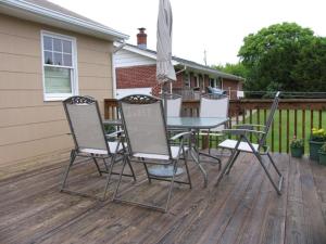 a table and chairs sitting on a deck at 103 Broadway The Broadway Breeze in Cape May