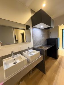 a bathroom with two sinks and a large mirror at Villa Monica 30sec in Noritake-Shinmachi +24 photos