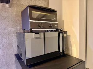 a toaster oven sitting on top of a counter at Villa Monica 30sec in Noritake-Shinmachi