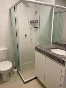 a bathroom with a shower and a toilet and a sink at Garden em Guarajuba in Tareco +7 photos