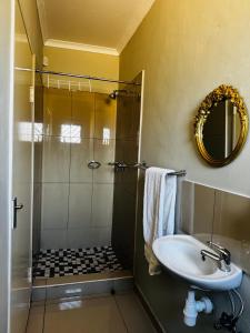 a bathroom with a shower and a sink at Graceful Getaway Air B&B in Rundu