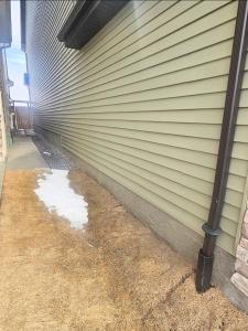 a house with a wall with snow on the side of it at Snug 2 bedroom sleeps 5-Netflix in Edmonton