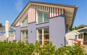 a house with red and white stripes on it at Seebrise B in Süssau +32 photos