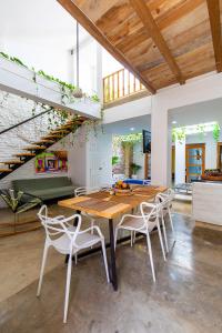 a dining room with a wooden table and chairs at House with Private Pool & Rooftop in Cartagena de Indias