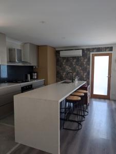 a kitchen with a island in the middle of a room at Green Acres in Gympie in Monkland
