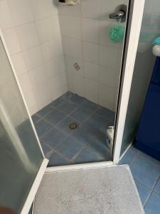 a shower with a blue floor in a bathroom at The Mango Tree in Fingal Bay +11 photos