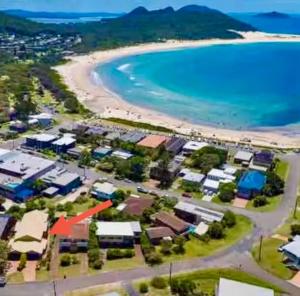 an aerial view of a resort next to a beach at The Mango Tree in Fingal Bay