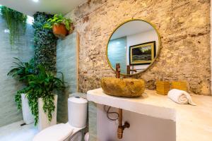 a bathroom with a sink and a mirror on a counter at House with Private Pool & Rooftop in Cartagena de Indias +22 photos