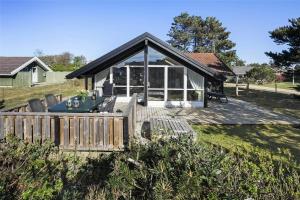 a house with a wooden deck in the yard at SL117-Slagelse-Egebaekvej-6 in Slagelse