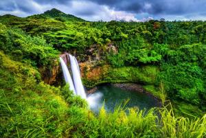 a waterfall in the middle of a lush green forest at Island Adventure Rooftop Camper fully equipped 4Runner in Anahola