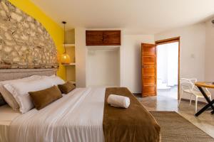 a bedroom with a large bed and a table at House with Private Pool & Rooftop in Cartagena de Indias