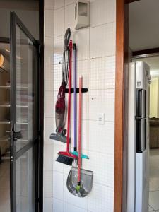 a kitchen with utensils hanging on a wall at Apartamento moderno - Amazonas Flat in Manaus +33 photos