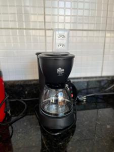 a black coffee maker sitting on a counter at Apartamento moderno - Amazonas Flat in Manaus