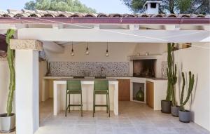 an open kitchen with two chairs and a table at Villa Rosalba in Olbia