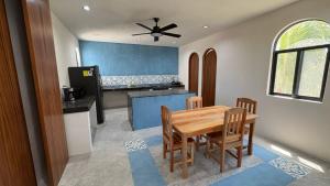 a dining room with a wooden table and chairs at Casa Laura Penthouse in El Cuyo