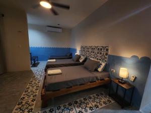 a bedroom with a large bed and a ceiling fan at Casa Laura Penthouse in El Cuyo