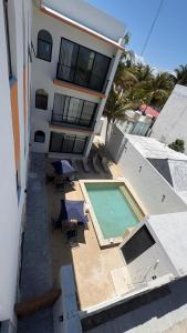 an aerial view of a building with a swimming pool at Casa Laura Penthouse in El Cuyo