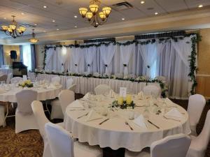 a banquet room with white tables and white chairs at Inn on Prince Hotel & Conference Centre, an Ascend Collection Hotel in Truro +125 photos