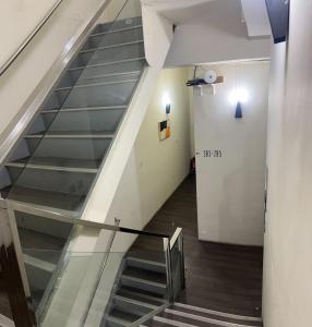 a staircase in a building with a glass railing at 好客輕旅 in Donggang