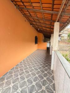 an empty hallway of a building with a tile floor at Próximo ao centro de Mariana MG in Mariana