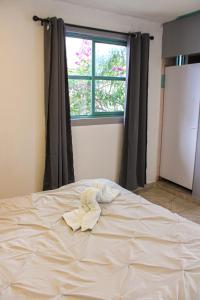 a bed with a pile of towels on top of it at Real Hotel y Alojamientos in Pachuca de Soto