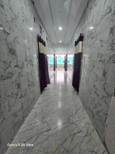 a corridor in a building with marble walls at Sree Guru Sannidhi in Jāmb