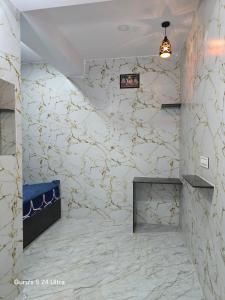 a room with a stone wall with a fireplace at Sree Guru Sannidhi in Jāmb