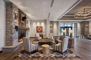 a living room with a couch and a fireplace at Choctaw Landing Casino & Resort, Trademark Coll by Wyndham in Broken Bow