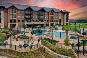 an exterior view of a hotel with a large building at Choctaw Landing Casino & Resort, Trademark Coll by Wyndham in Broken Bow