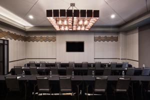 a conference room with a table and chairs at Choctaw Landing Casino & Resort, Trademark Coll by Wyndham in Broken Bow +47 photos