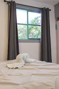 an unmade bed in a bedroom with a window at Real Hotel y Alojamientos in Pachuca de Soto +5 photos