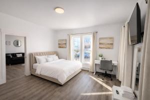 a bedroom with a bed and a desk and a television at Mohegan Sun Getaway Large Group Retreat in Danielson