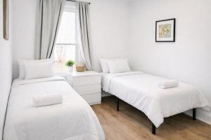 a bedroom with two beds and a window at Mohegan Sun Getaway Large Group Retreat in Danielson