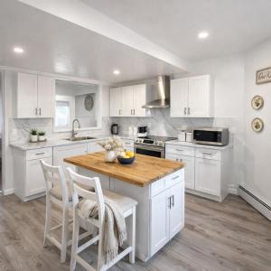 a kitchen with white cabinets and a wooden counter top at Mohegan Sun Getaway Large Group Retreat in Danielson