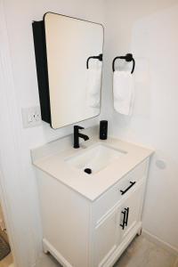 a bathroom with a white sink and a mirror at Mohegan Sun Getaway Large Group Retreat in Danielson +10 photos