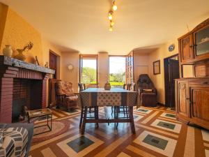 a living room with a table and a fireplace at Maison avec parking - 7 pers. - FR-1-591-784 in Éguzon-Chantôme