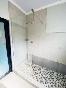 a shower with a glass door in a bathroom at The Exec Place Maun in Maun +11 photos