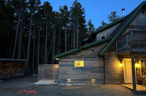 a cabin with lights on the side of it at night at Quietside Studio - Fire Pit - Near Acadia in Southwest Harbor