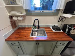 a kitchen with a sink in a tiny house at Quietside Studio - Fire Pit - Near Acadia in Southwest Harbor