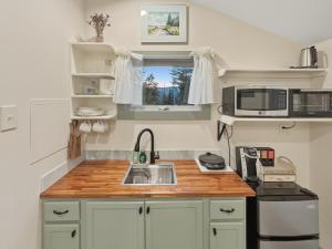 a kitchen with a sink and a microwave at Quietside Studio - Fire Pit - Near Acadia in Southwest Harbor +12 photos
