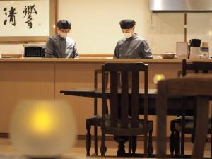 two chefs wearing masks at a counter in a restaurant at Yuzanso in Otsu +133 photos
