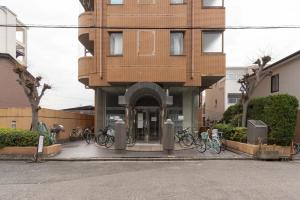 a building with bikes parked in front of it at アンドステイ屋形町704 in Kyoto