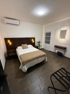 a bedroom with a bed and a chair in it at Casa Legado in Orizaba