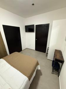 a bedroom with a bed and two black doors at Casa Legado in Orizaba +34 photos
